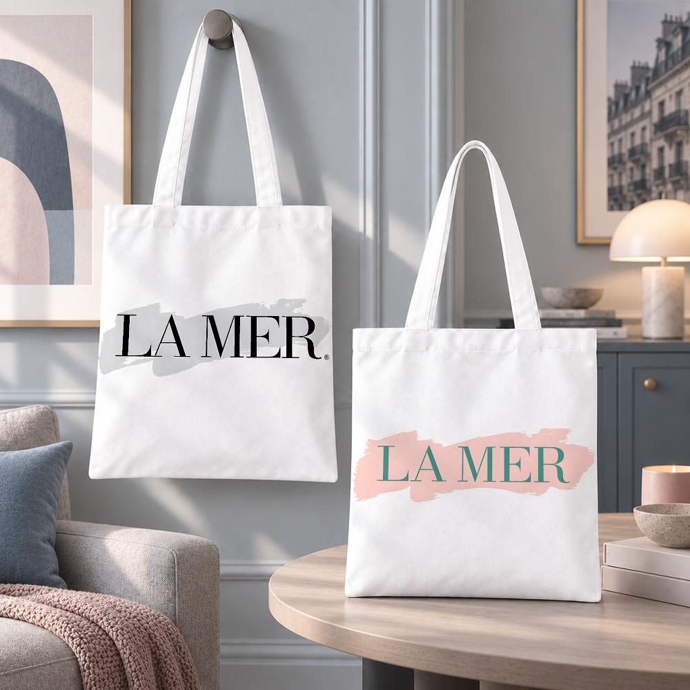 Luxury Skincare Shop - ラ・メールの高級スキンケア製品用収納バッグ。環境に配慮したキャンバス地のトートバッグ。無臭で再利用可能。両面プリントのショッピングバッグ。